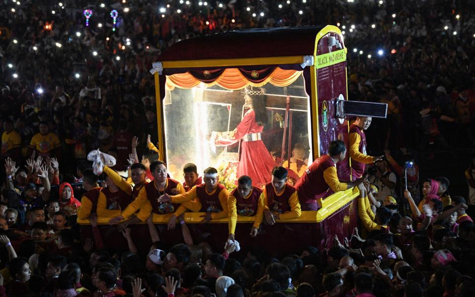 The icon is a wooden depiction of Jesus carrying a heavy cross