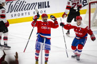Washington Capitals left wing Alex Ovechkin (8), from Russia, celebrates with center Nicklas Backstrom (19), from Sweden, after scoring his third goal of the night for a hat trick, during the third period of an NHL hockey game against the New Jersey Devils, Thursday, Jan. 16, 2020, in Washington. The Capitals won 5-2. (AP Photo/Al Drago)