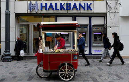 FILE PHOTO: A street vendor sells roasted chestnuts in front of a branch of Halkbank in central Istanbul, Turkey, January 10, 2018. REUTERS/Murad Sezer/File Photo