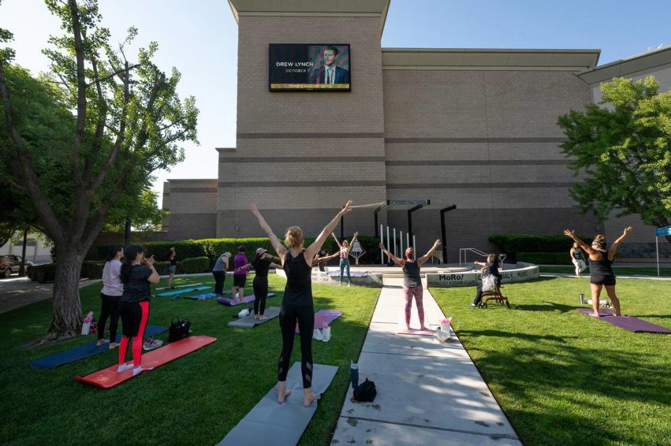 Studio V instructor Victoria Popoff leads a free pilates class at the Modesto Rotary Music Garden outside the Gallo Center for the Arts in Modesto, Calif., Saturday, August 5, 2023.