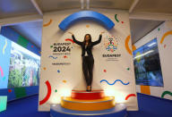 A hostess poses with Hungary's Olympic logo at a promotional spot as the Hungarian capital bids for the 2024 Olympic Games, in central Budapest, Hungary January 31, 2017. REUTERS/Laszlo Balogh