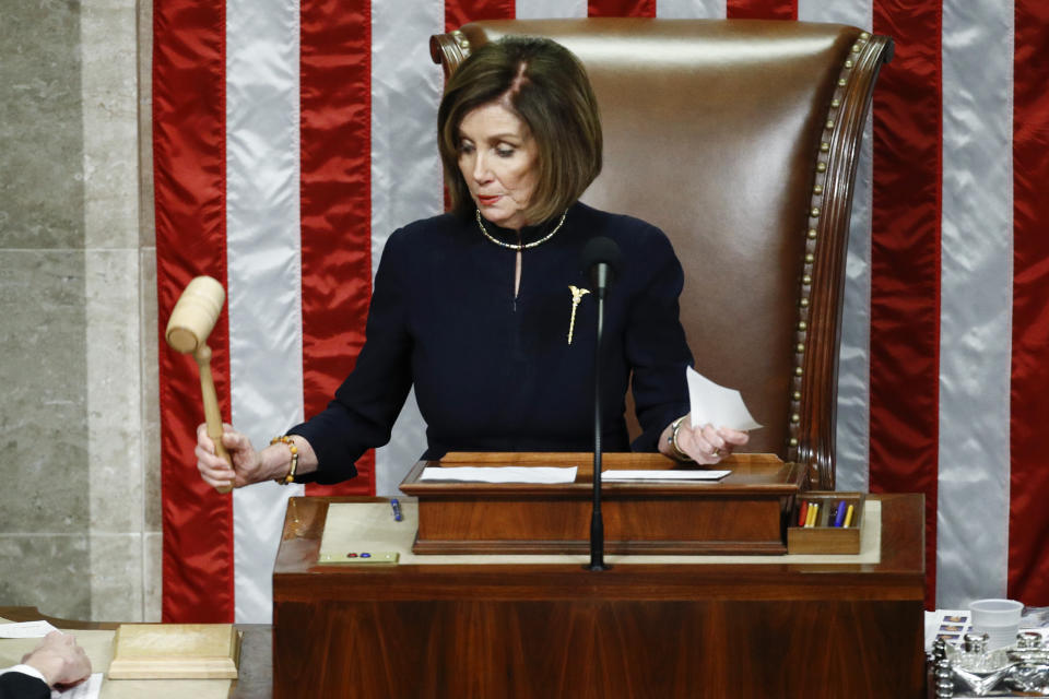 FILE - House Speaker Nancy Pelosi of Calif., strikes the gavel after announcing the passage of article II of impeachment against President Donald Trump, Dec. 18, 2019, on Capitol Hill in Washington. (AP Photo/Patrick Semansky, File)