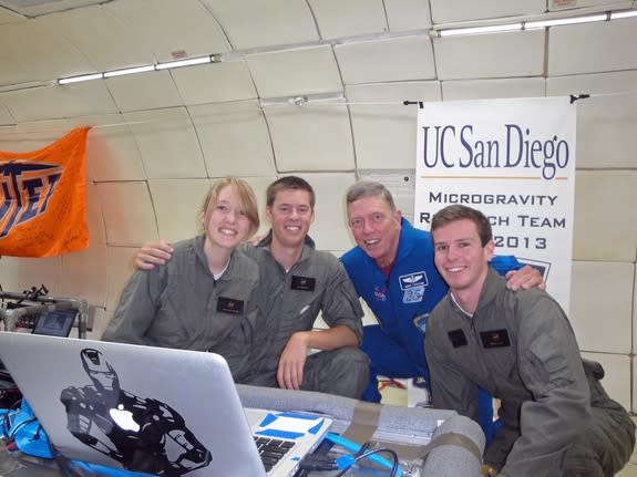 NASA astronaut Mike Fossum poses for a snapshot with the UC San Diego Microgravity Team during a weightless research flight with NASA's Microgravity University on July 19, 2013. The team studied how biofuels burn in zero-gravity conditions.