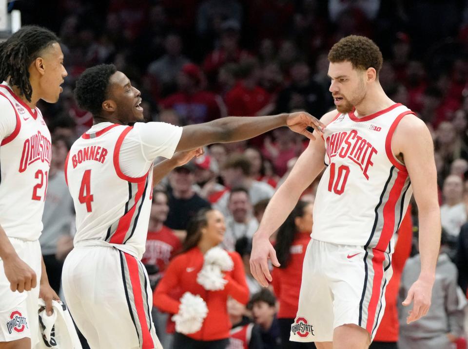 Feb. 29, 2024; Columbus, Ohio, USA; 
Ohio State Buckeyes forward Devin Royal (21), Ohio State Buckeyes guard Dale Bonner (4) and Ohio State Buckeyes forward Jamison Battle (10) celebrate after a play during the second half of an NCAA Division I men's basketball game on Thursday at Value City Arena. Ohio State won the game 78-69.