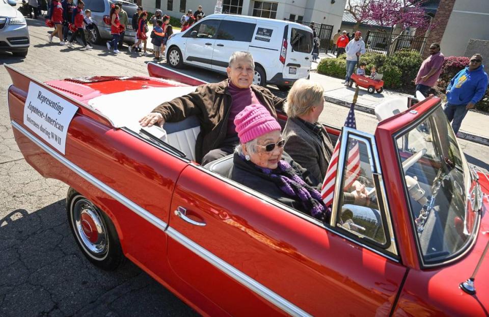 Marion Masada and Robert Shintaku, both of Fresno, ride in Pinedale’s centennial celebration parade on Saturday, March 25, 2023. Masada and Shintaku, who were held in an Arizona internment camp during World War II, helped get the Pinedale Assembly Center memorial built to honor and remember those Japanese Americans detained there.