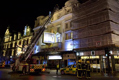 Emergency services look at the roof of the Apollo Theatre on Shaftesbury Avenue after part of the ceiling collapsed in central London December 19, 2013. REUTERS/Neil Hall