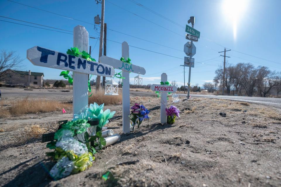 A roadside memorial for Trenton, Ada and Mckenzie Frazier is placed at the intersection of U.S. Highway 50 and 36th Lane in Pueblo.