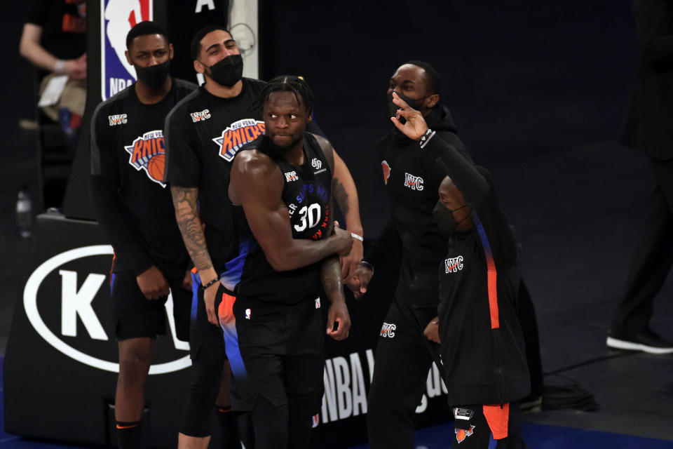 New York Knicks forward Julius Randle (30) reacts with teammates after making a 3-point basket during overtime of an NBA basketball game against the New Orleans Pelicans on Sunday, April 18, 2021, in New York. (AP Photo/Adam Hunger, Pool)