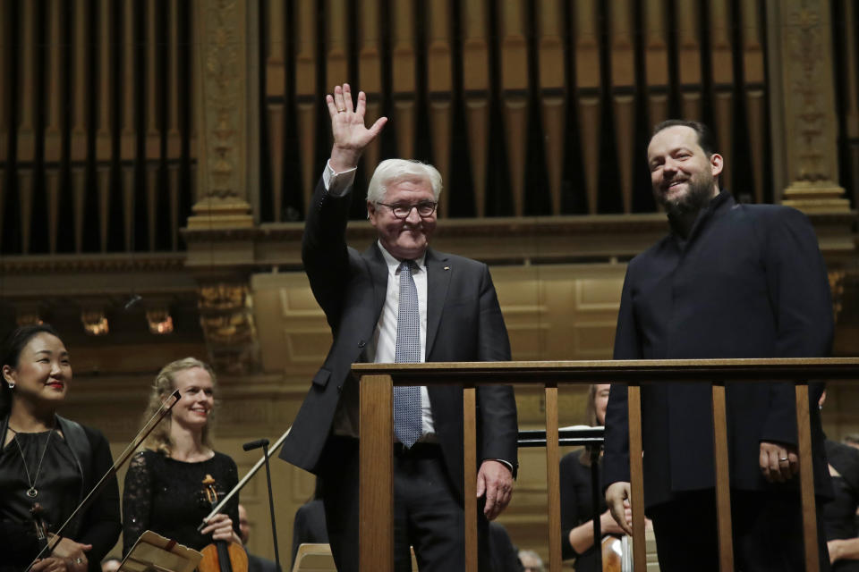 German President Frank-Walter Steinmeier waves to the audience alongside BSO conductor Andris Nelsons, right, prior to a joint concert of the Boston Symphony Orchestra and Germany's visiting Leipzig Gewandhaus Orchestra, Thursday, Oct. 31, 2019, at Symphony Hall in Boston. (AP Photo/Elise Amendola)