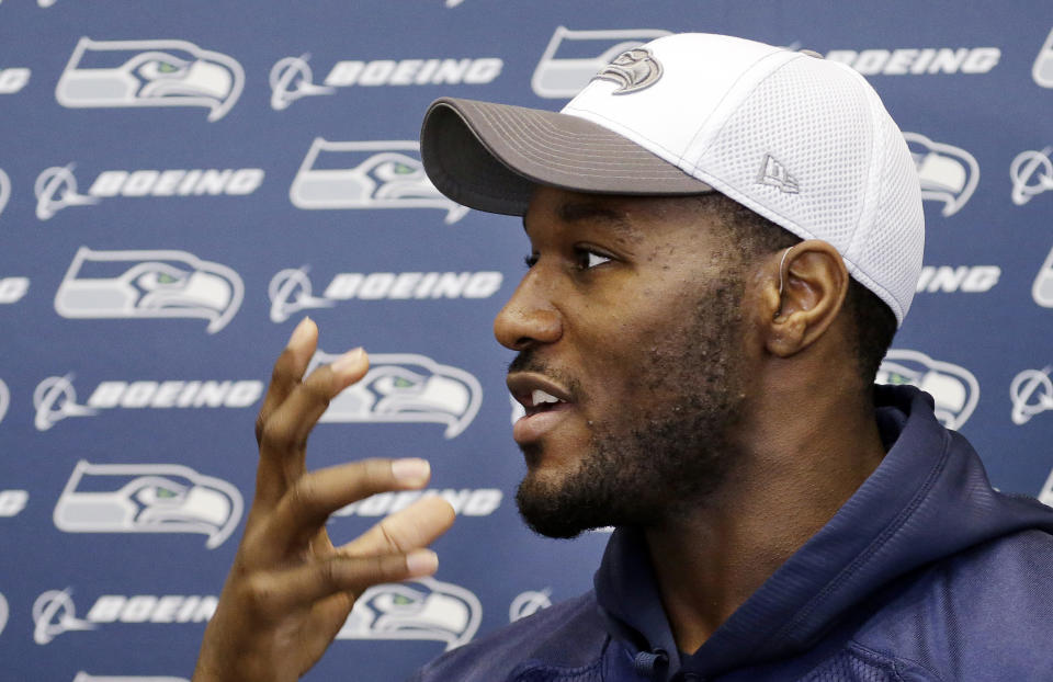 Seattle Seahawks' Derrick Coleman speaks with members of the media about how he can read lips, before an NFL football practice Thursday, Jan. 16, 2014, in Renton, Wash. Coleman, who is hearing impaired, has hearing aids in both ears. The Seahawks are to play the San Francisco 49ers on Sunday in the NFC championship game. (AP Photo/Elaine Thompson)