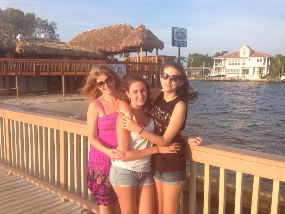 The author, pictured right, with her mother and sister at the Yacht Club in Cape Coral, FL in April 2014. The Boathouse was destroyed during Hurricane Ian and the pier no longer stands.