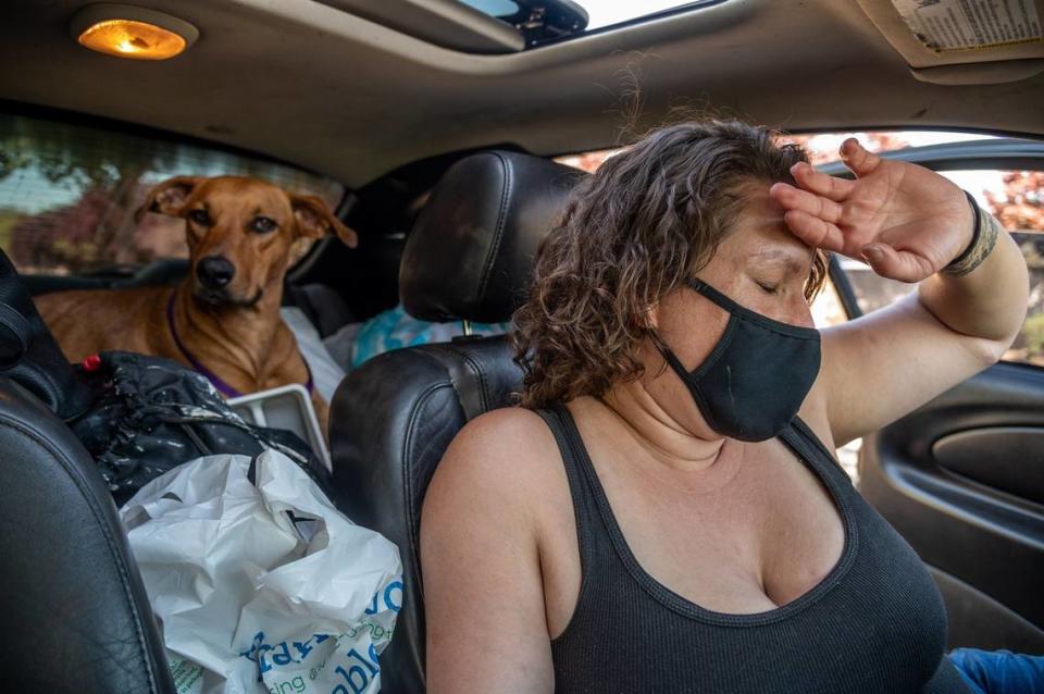 Britt Macias lives in her car with her dogs in 2021, before she and the animals were able to move into the Vagabond Inn as part of Project Roomkey.