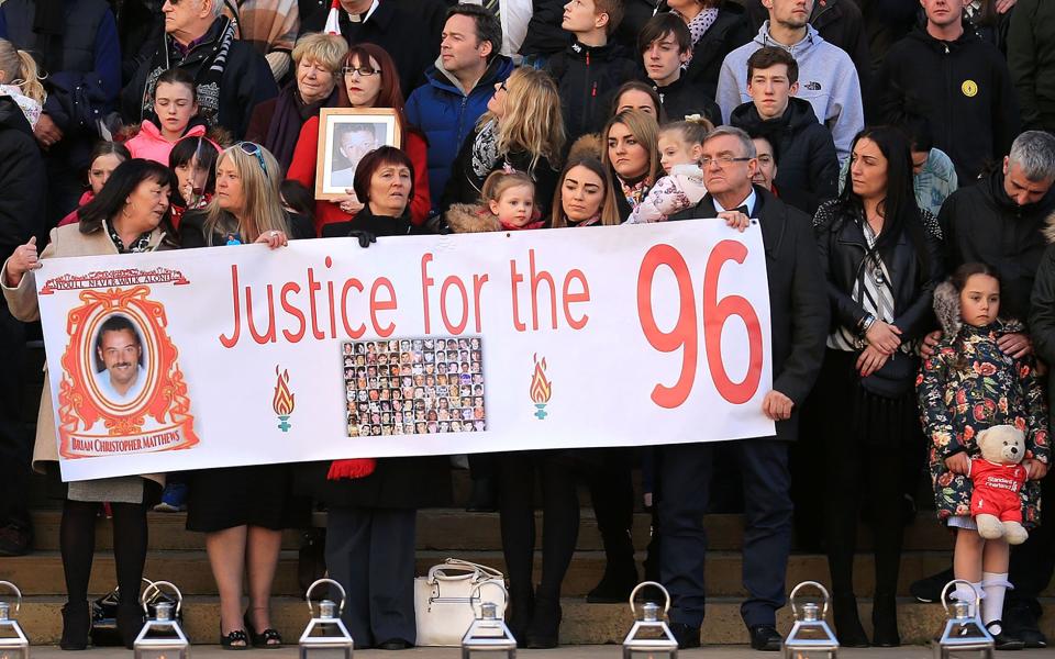 Banners are held outside Liverpool's Saint George's Hall during an April 2016 vigil for the 96 victims of the Hillsborough tragedy - Credit: Christopher Furlong/Getty Images