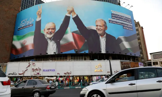 <span>A billboard in Tehran shows the late Hamas leader Ismail Haniyeh (left) joining hands with the Iranian president, Masoud Pezeshkian.</span><span>Photograph: Vahid Salemi/AP</span>