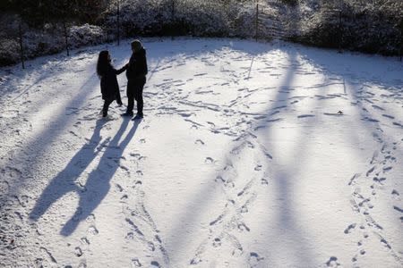 A man and woman stand in a snow covered path at Central Park in New York, U.S., January 6, 2017. REUTERS/Shannon Stapleton