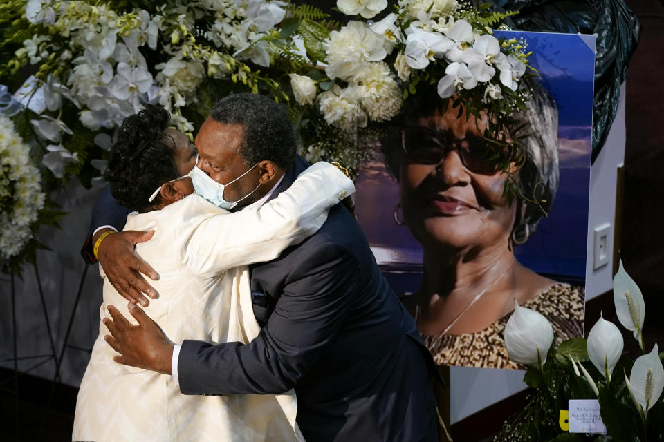 FILE - A mourner embraces Angela Crawley, left, daughter of Ruth Whitfield, a victim of the Buffalo supermarket shooting, before a memorial service at Mt. Olive Baptist Church with Vice President Kamala Harris in attendance, Saturday, May 28, 2022, in Buffalo, N.Y. The Tops Friendly Markets where 13 people were gunned down by a white gunman is set to reopen its doors Thursday, July 14 two months after the racist attack. (AP Photo/Patrick Semansky, File)