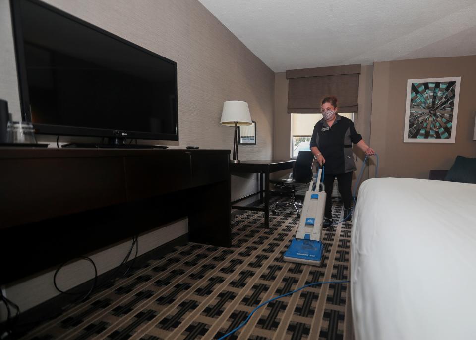Wendy Preston vacuums the floor in a hotel room on Wednesday at Hotel Marshfield in Marshfield.