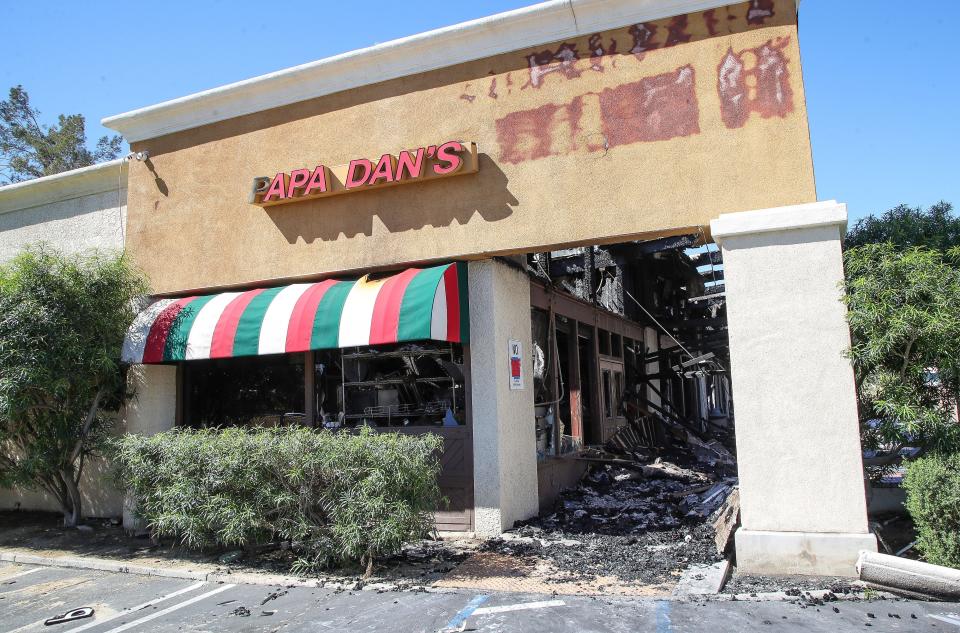 A building in the Plaza De Monterey Shoping Center that contained Papa Dan's, D'Coffee Bouteaque, Miracle Ear and Reverse Mortgage Works was destroyed by fire in the early morning of April 15, 2024 in Palm Desert, Calif..