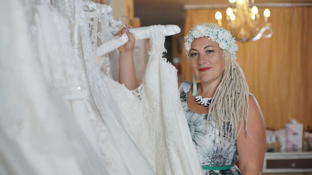 Samm Buca changed her name legally five years ago. She is seen here holding up a wedding dress.