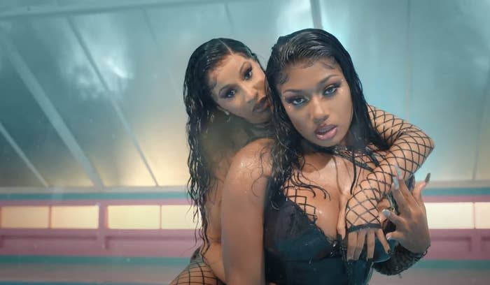 Cardi B with her arm seductively around Megan Thee Stallion