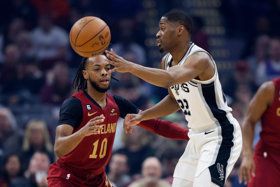 San Antonio Spurs guard Malaki Branham passes against Cavaliers guard Darius Garland during the first half, Monday, Feb. 13, 2023, in Cleveland.