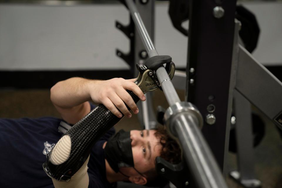 Manna gets ready to bench press. "I could throw anything at him and there would be no excuses. He wanted to try everything," a former trainer says.