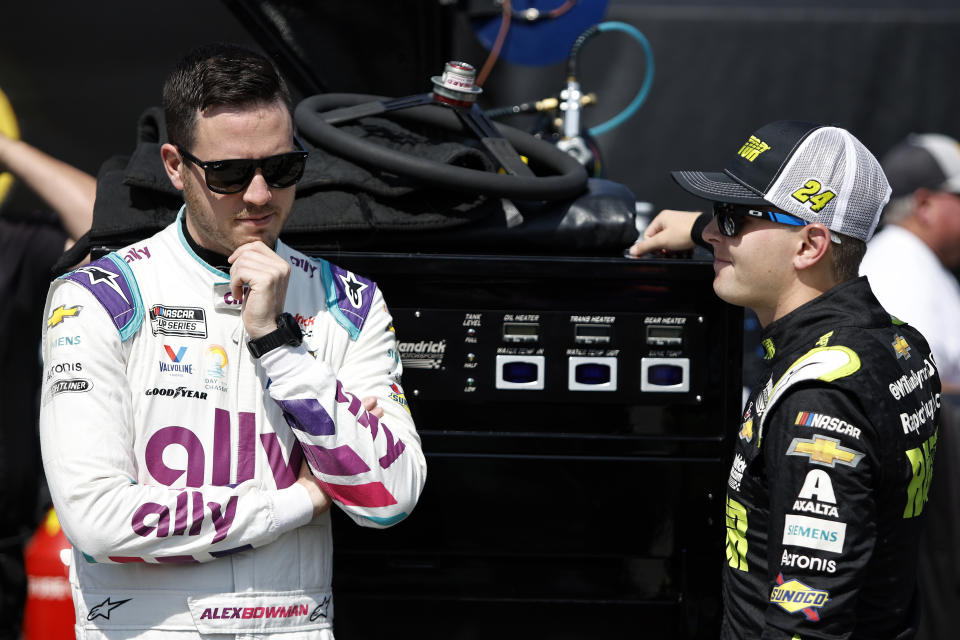 ELKHART LAKE, WISCONSIN - JULY 02: Alex Bowman, driver of the #48 Ally Chevrolet, (L) and William Byron, driver of the #24 RaptorTough.com Chevrolet, talk in the garage area during practice for the NASCAR Cup Series Kwik Trip 250 at Road America on July 02, 2022 in Elkhart Lake, Wisconsin. (Photo by Sean Gardner/Getty Images)