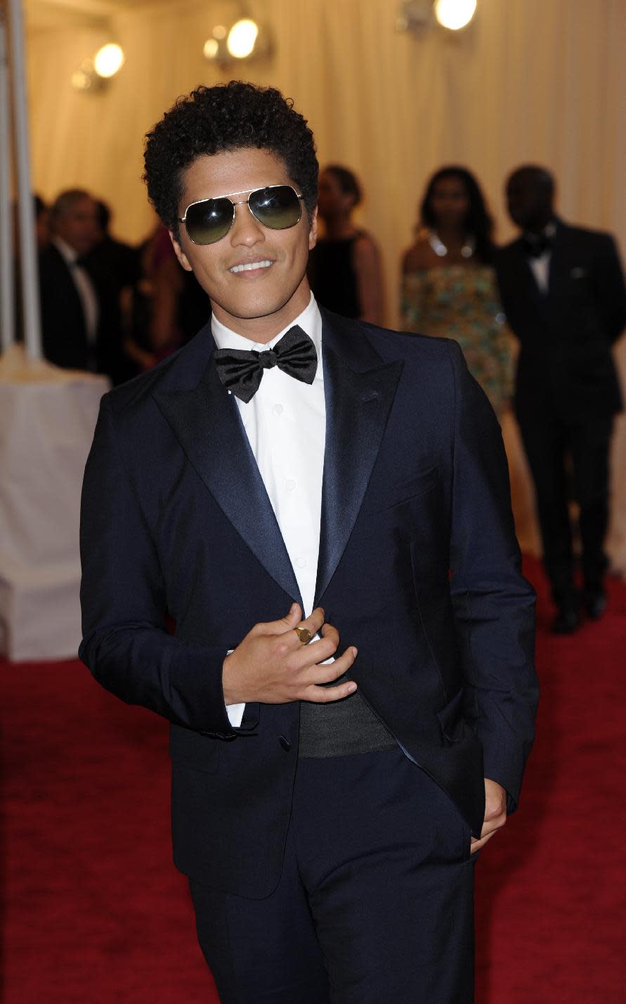 Bruno Mars arrives at the Metropolitan Museum of Art Costume Institute gala benefit, celebrating Elsa Schiaparelli and Miuccia Prada, Monday, May 7, 2012 in New York. (AP Photo/Evan Agostini)