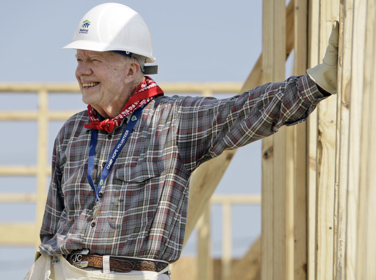 Former President Jimmy Carter leans on a wall as he helps build a Habitat for Humanity house in Violet, La., in 2007. 