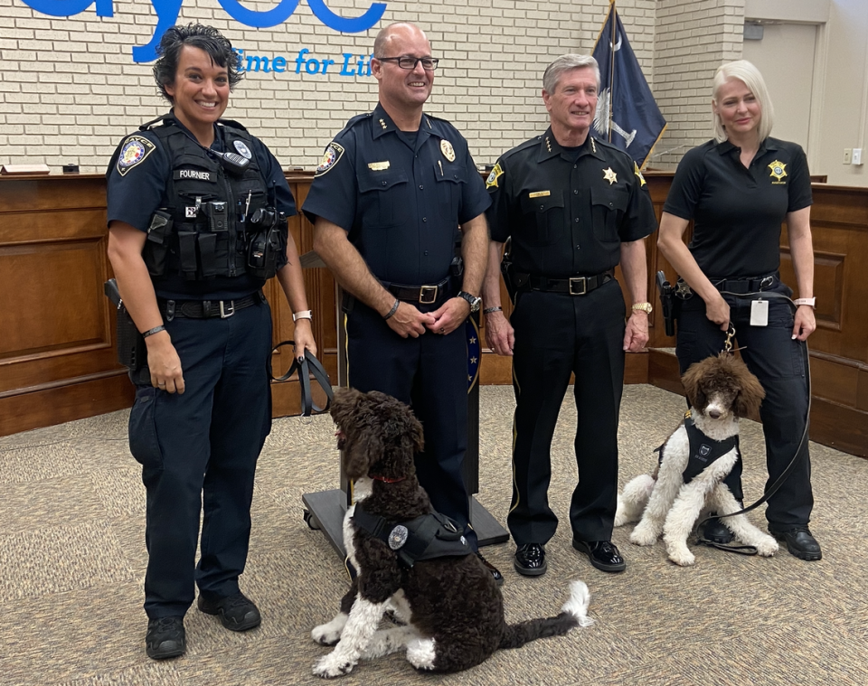 From right, Cayce Police Officer Mandi Fournier with Hudson, Cayce Police Chief Chris Cowan, Richland County Sheriff Leon Lott, and Richland County Investigator Summer Pearrow with Leona.