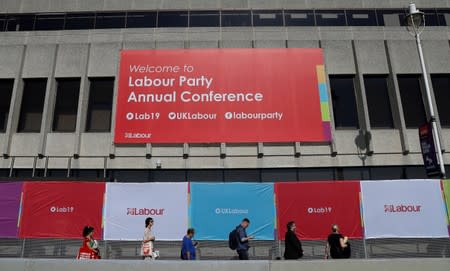 People walk past the Brighton Centre where the Labour Party Annual Conference is being held, in Brighton