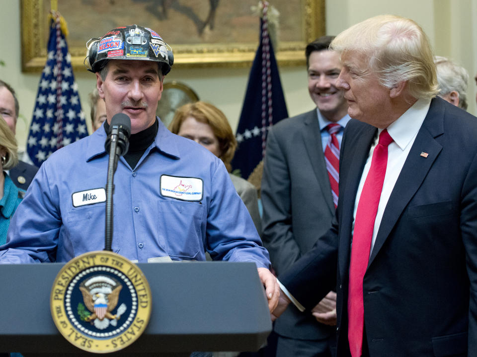 President Donald Trump gives the floor to a coal miner at the signing of a bill deregulating the industry. Warren's critics doubt her appeal with working-class voters. (Photo: Ron Sachs-/Pool/Getty Images)