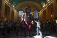 A large puppet named Little Amal walks around Grand Central Station in New York, Thursday, Sept. 15, 2022. New York City's latest celebrity visitor is stopping traffic even in this jaded, larger-than-life town. Little Amal, a 12-foot puppet of a 10-year-old Syrian refugee, is on a 17-day blitz through every corner of the Big Apple as part of a theater project hoping to raise awareness about immigration. (AP Photo/Seth Wenig)