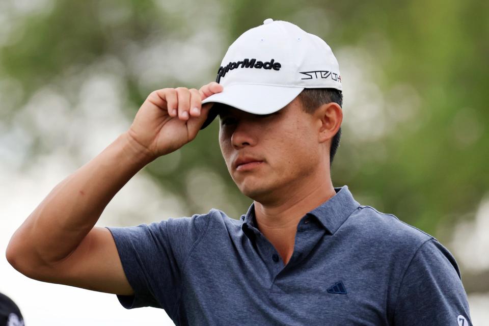 Collin Morikawa tips his hat to the crowd after finishing a 65 on Thursday in the first round of The Players Championship.