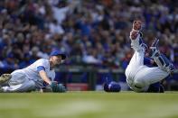 Chicago Cubs catcher Yan Gomes collides with Chicago Cubs starting pitcher Drew Smyly, preventing the throw to first base and ending his chance at a perfect game during the eighth inning of a baseball game against the Los Angeles Dodgers Friday, April 21, 2023, in Chicago. (AP Photo/Erin Hooley)