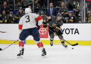 Vegas Golden Knights left wing William Carrier (28) looks to shoot the puck as Florida Panthers' Keith Yandle defends during the second period of an NHL hockey game Saturday, Feb. 22, 2020, in Las Vegas. (AP Photo/Marc Sanchez) ///