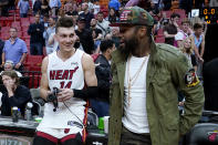 Miami Heat guard Tyler Herro, left, stands with former boxer Floyd Mayweather Jr. after the team's NBA basketball game against the Atlanta Hawks, Friday, April 8, 2022, in Miami. The Heat won 113-109. (AP Photo/Lynne Sladky)