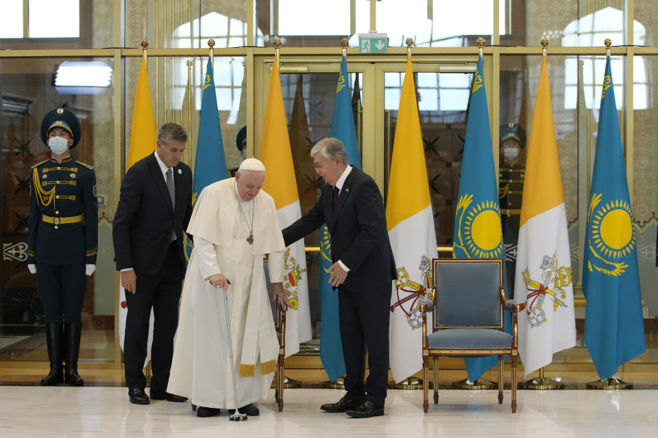 Pope Francis, left, meets the Kazakhstan's President Kassym-Jomart Tokayev as he arrives at Our-Sultan's International airport in Nur-Sultan, Kazakhstan, Tuesday, Sept. 13, 2022. Pope Francis begins a 3-days visit to the majority-Muslim former Soviet republic to minister to its tiny Catholic community and participate in a Kazakh-sponsored conference of world religious leaders. (AP Photo/Andrew Medichini)