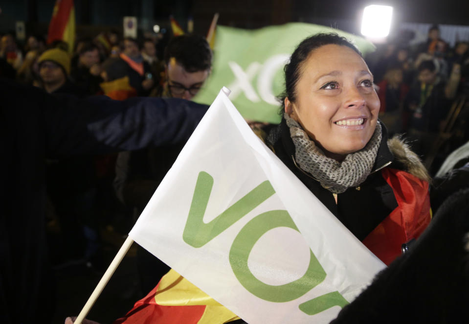 A supporter of Spain's far-right Vox party smiles outside the party headquarters after the announcement of the general election first results, in Madrid, Spain, Sunday, Nov. 10, 2019. Spain's Interior Ministry says that early results show Socialists winning Spain's national election, but without a clear end to the country's political deadlock. Vox is also surging to become the country's third political force, more than doubling its presence in the parliament's lower house from 24 to 53 deputies only six months after its debut. (AP Photo/Andrea Comas)