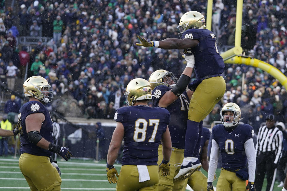 Notre Dame running back Audric Estime (7) celebrates with Joe Alt after Estime ran in for a touchdown during the first half of an NCAA college football game, Saturday, Nov. 19, 2022, in South Bend, Ind. (AP Photo/Darron Cummings)