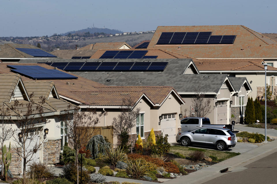 FILE—Solar panels sit on rooftops at a housing development in Folsom, Calif., Wednesday, Feb. 12, 2020. A plan released by the California Air Resources Board on Tuesday, May 10, 2022, says the state will need to dramatically increase its solar power to meet ambitious climate change goals. The plan says the state should reduce its reliance on petroleum by 91% by 2045. (AP Photo/Rich Pedroncelli, File)