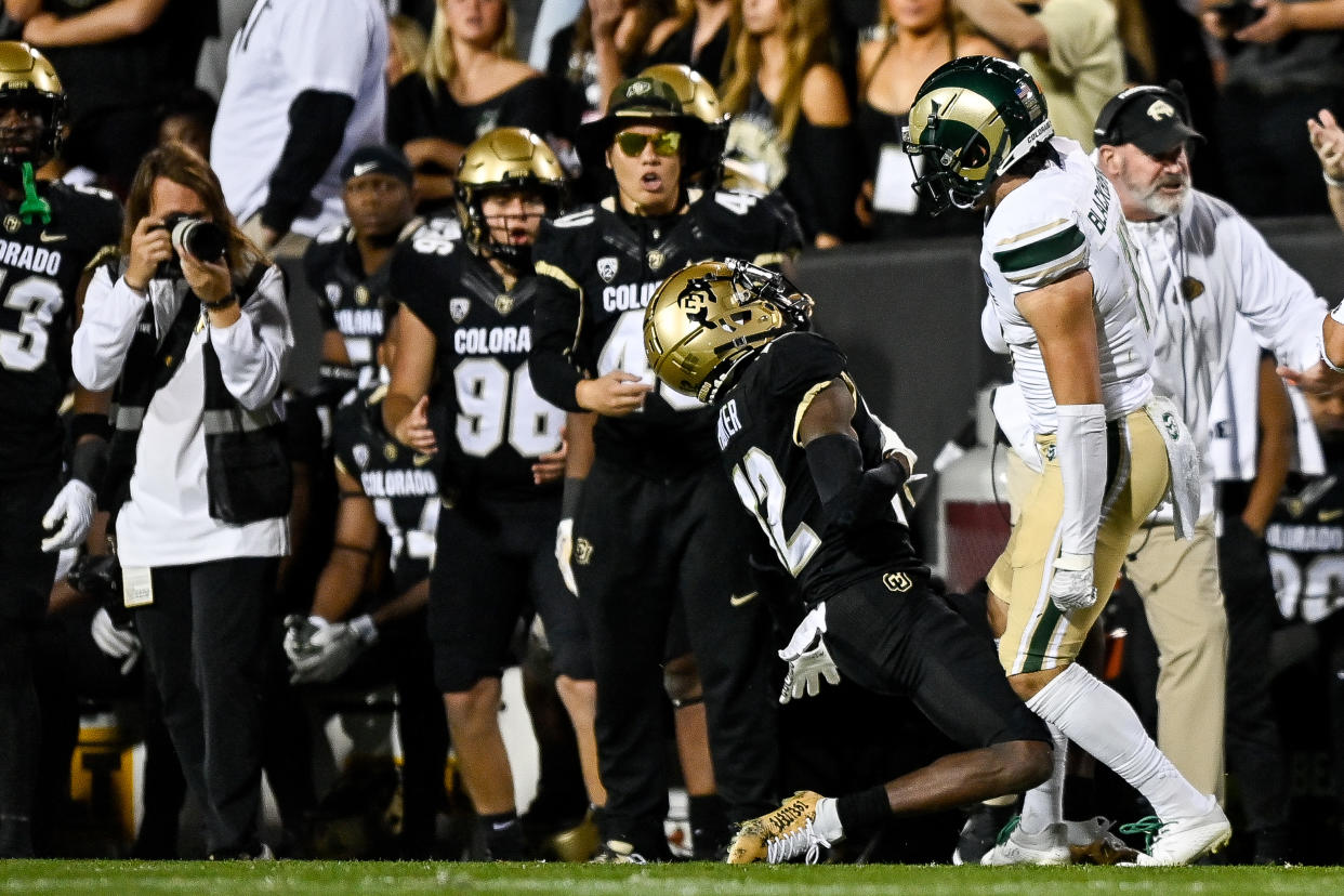 Colorado Buffaloes WR Travis Hunter is hit near the sideline by Colorado State's Henry Blackburn on Sept. 16. (Dustin Bradford/Getty Images)