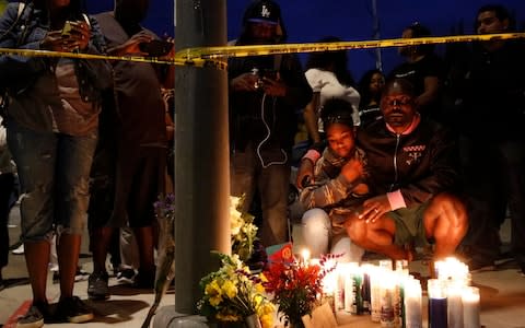 Fans pay tribute to Nipsey Hussle on the Los Angeles street where he was shot - Credit: AP
