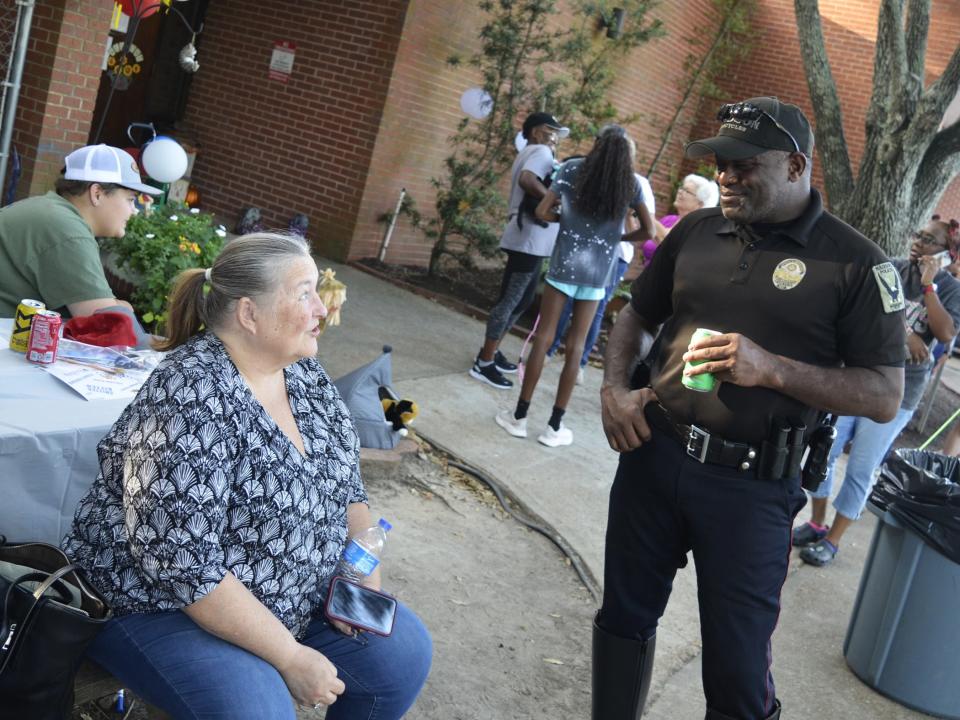 Madison Police Capt. Stephen Patrick talks with Jean Dunn of Madison during National Night Out festivities held at the Webster Animal Shelter in Madison on Tuesday, Oct. 3.