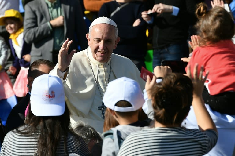 Pope Francis (centre) greets worshippers as he arrives for a Holy Mass at the stadium in Tbilisi, on October 1, 2016