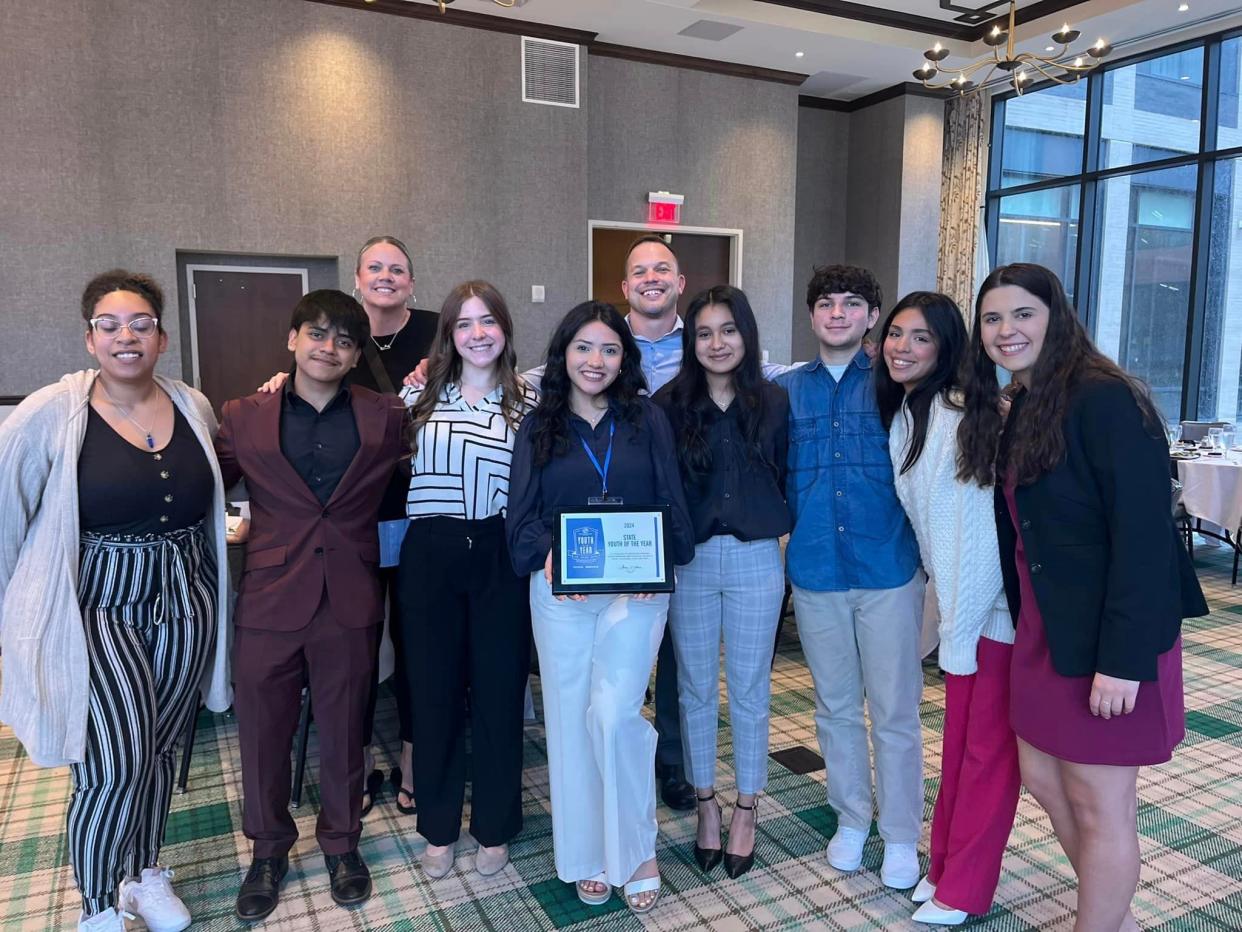 Jaquelin Barajas, center, stands with fellow members and staff from Boys and Girls Club of Greater Holland after being named Michigan's Youth of the Year.