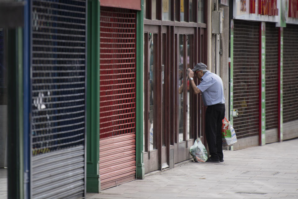 CARDIFF, UNITED KINGDOM - MAY 21: A man looks in the window of a closed coffee shop during the coronavirus lockdown period on May 21, 2020 in Cardiff, United Kingdom. The British government has started easing the lockdown it imposed two months ago to curb the spread of Covid-19, abandoning its 'stay at home' slogan in favour of a message to 'be alert', but UK countries have varied in their approaches to relaxing quarantine measures. (Photo by Matthew Horwood/Getty Images)