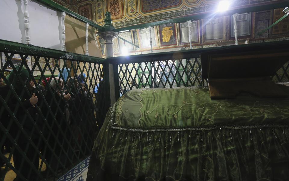 Tunisian women pray near grave of Sidi Sahibi at mausoleum ahead of Eid-e-Milad-ul-Nabi, birthday of Prophet Mohammad, in Kairouan