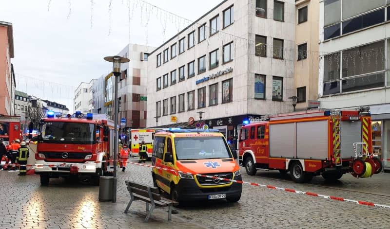 Fire and rescue services work at the scene in the city center after a truck has driven into a group of pedestrians in Passau city center, injuring several people and killing one woman. The lorry driver is also on his way to hospital, said a police spokesman. -/Zema Medien/dpa