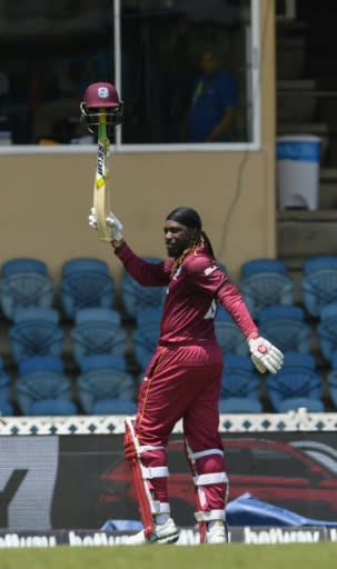 Chris Gayle of West Indies waves to fans while walking off the field